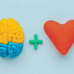 Brain and heart symbols made of clay, representing the balance of IQ and EQ in governance.