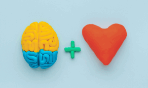 Brain and heart symbols made of clay, representing the balance of IQ and EQ in governance.