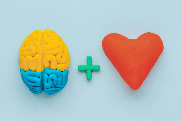 Brain and heart symbols made of clay, representing the balance of IQ and EQ in governance.
